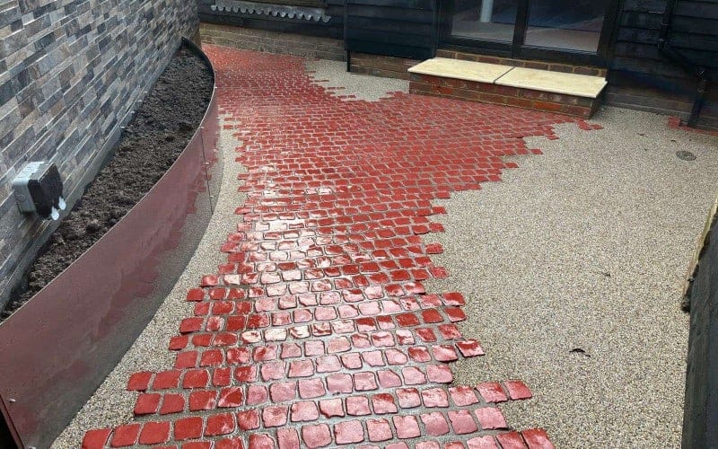A red pathway as part of a hard landscaping project.